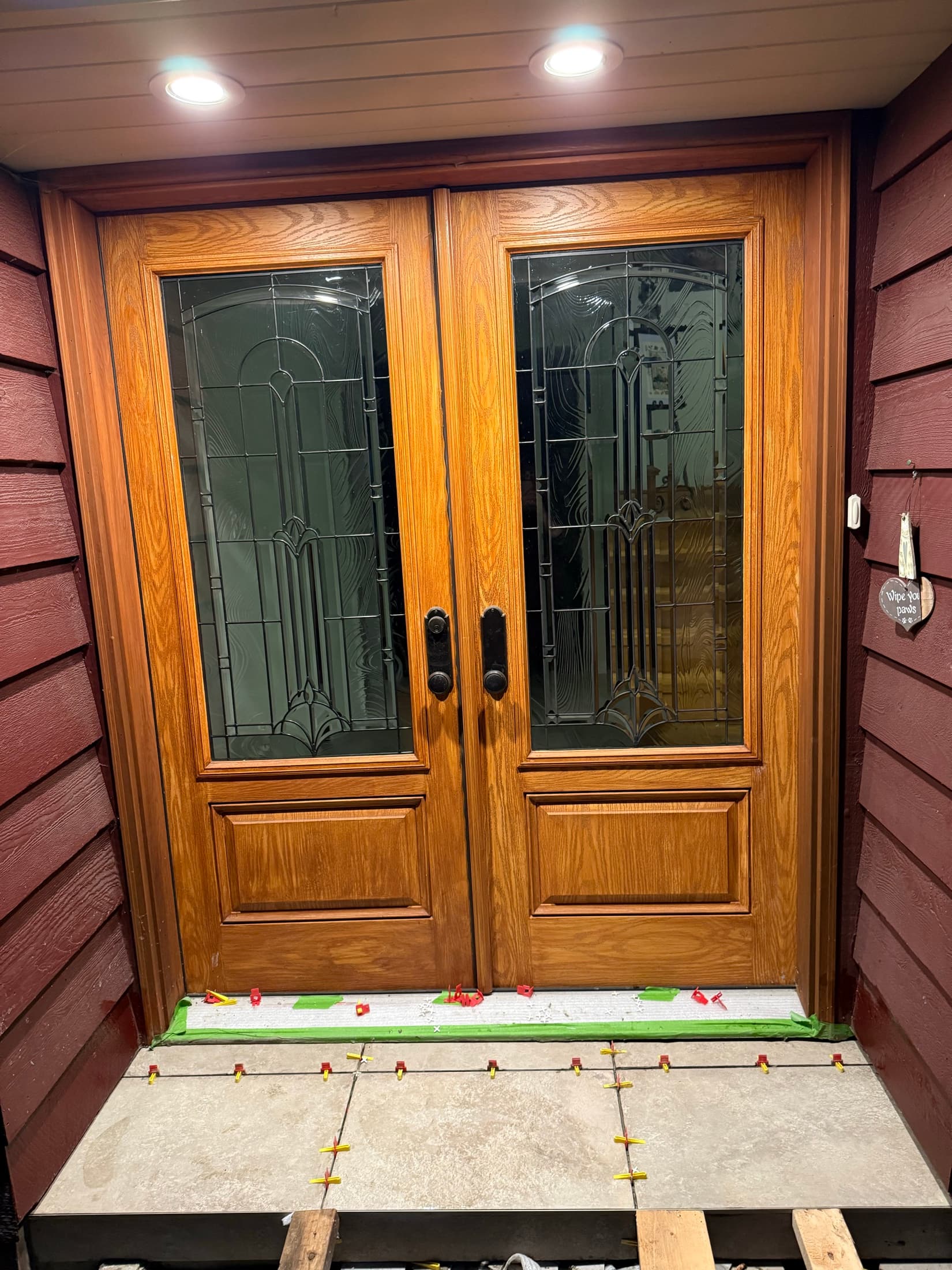 Glass-panel entry door installation with tile threshold